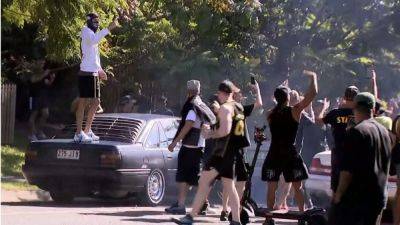 Video: Police cars damaged in Queensland hooning event, two men charged