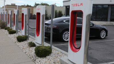 Tesla's EV charging team layoffs threaten to slow Biden's program to electrify highways